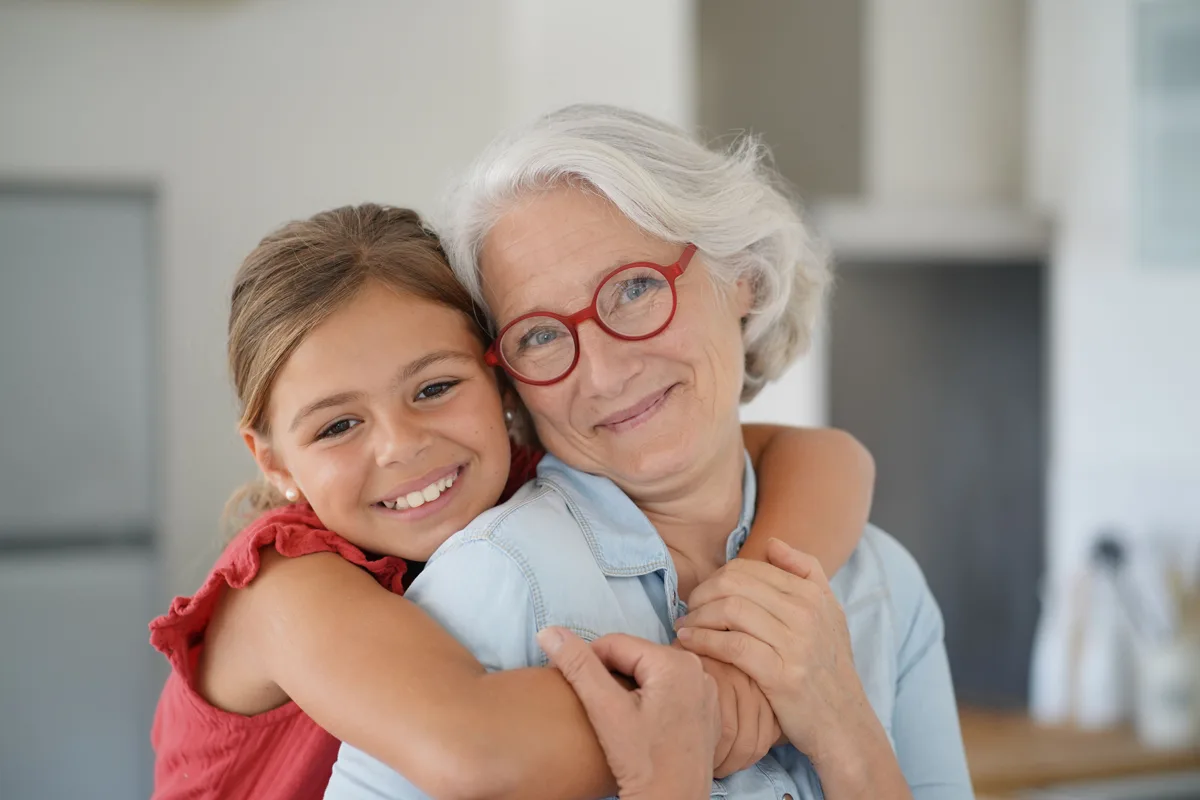 Grandmother hugging a child